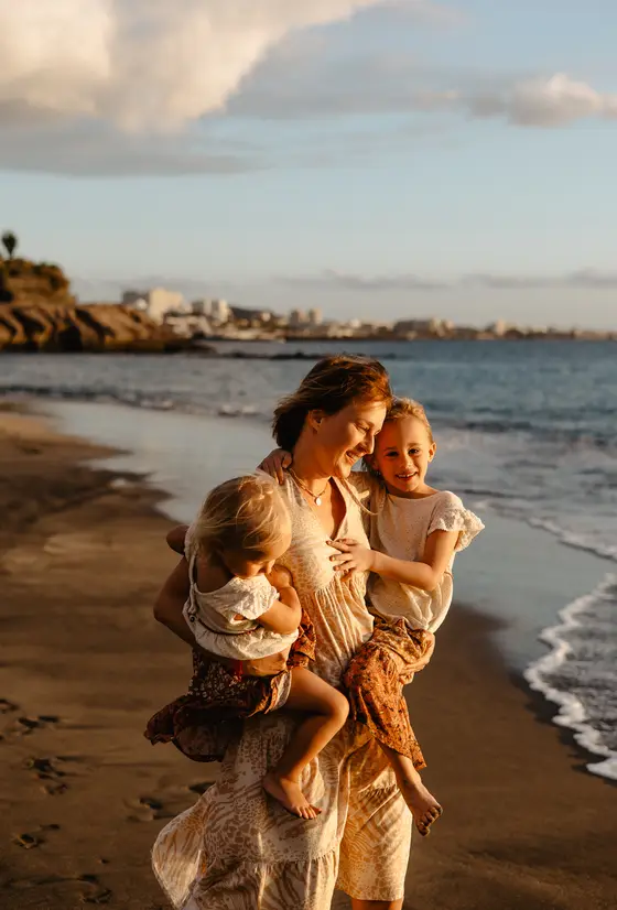 Mother with two children on beach during golden hour lifestyle photography session